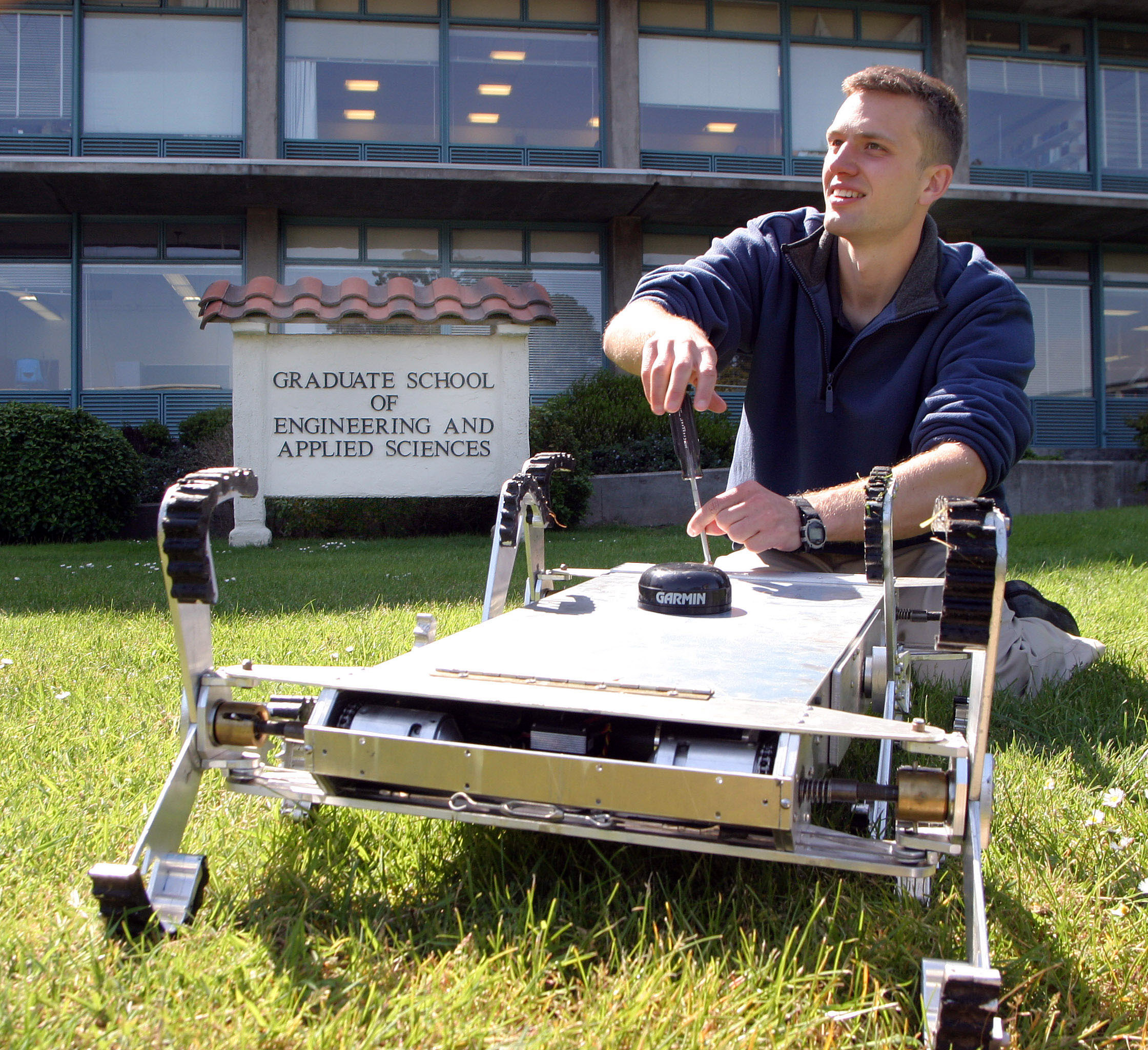Monterey, Calif. (April 27, 2006) - Combat Systems Sciences and Technology Program Naval Postgraduate student Ensign Tom Dunbar, works with an autonomous robot originally designed to maneuver in agricultural settings. The autonomous robot, dubbed AGBOT, has been modified though to conduct its operations in the surf zone. – U.S. Navy photo by Javier Chagoya (RELEASED)